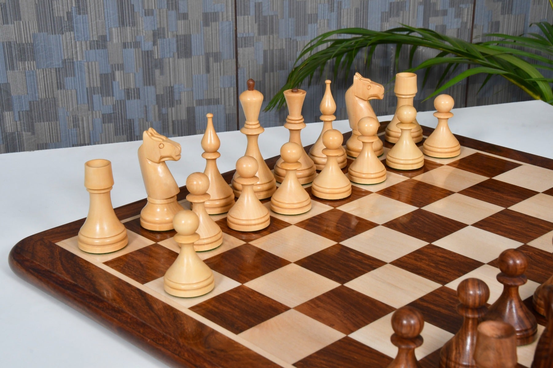 Sheesham chess pieces set up for play on the included 48cm sheesham and boxwood board