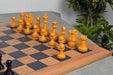 Ebonised chess pieces set up for play on the included 55cm poplar veneer board