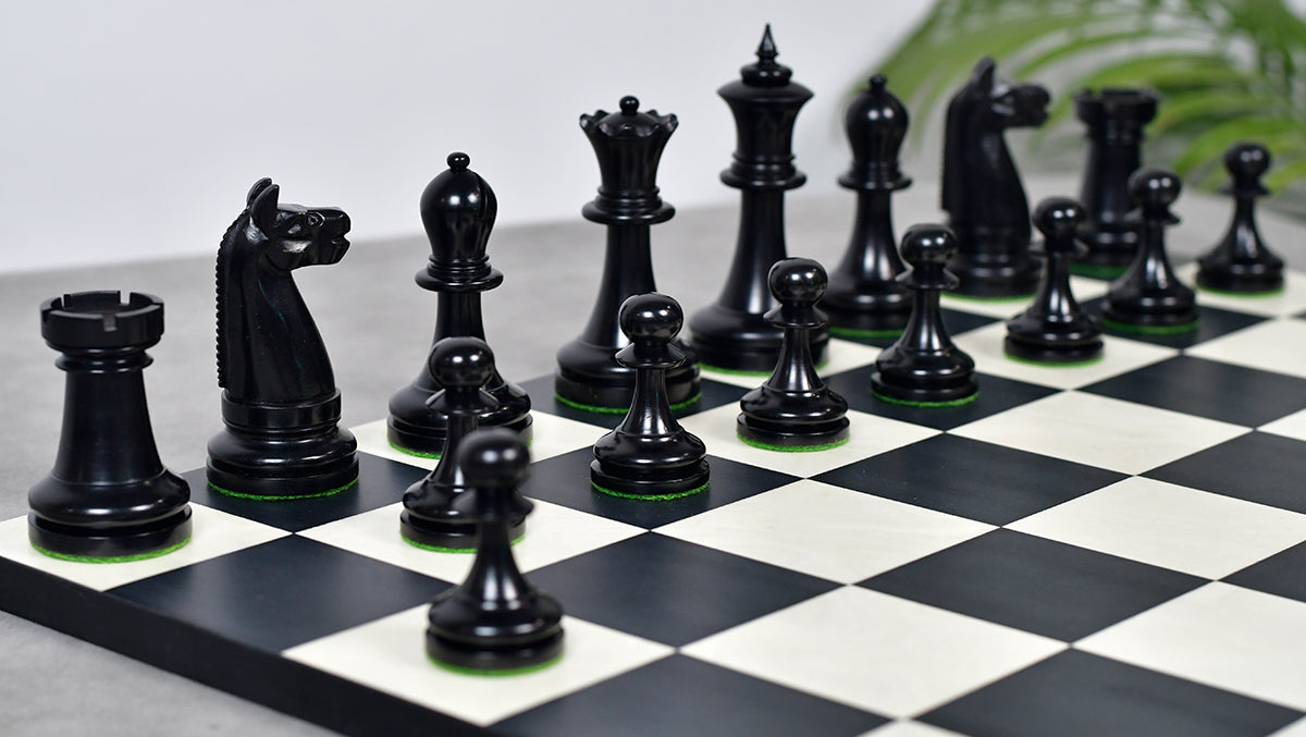 Ebonised chess pieces with a 97mm king and weighted felted bases