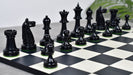 Ebonised chess pieces with a 97mm king and weighted felted bases