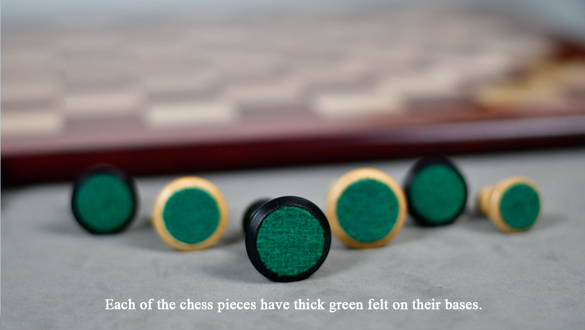Natural and ebonised boxwood Staunton chessmen with green felted bases