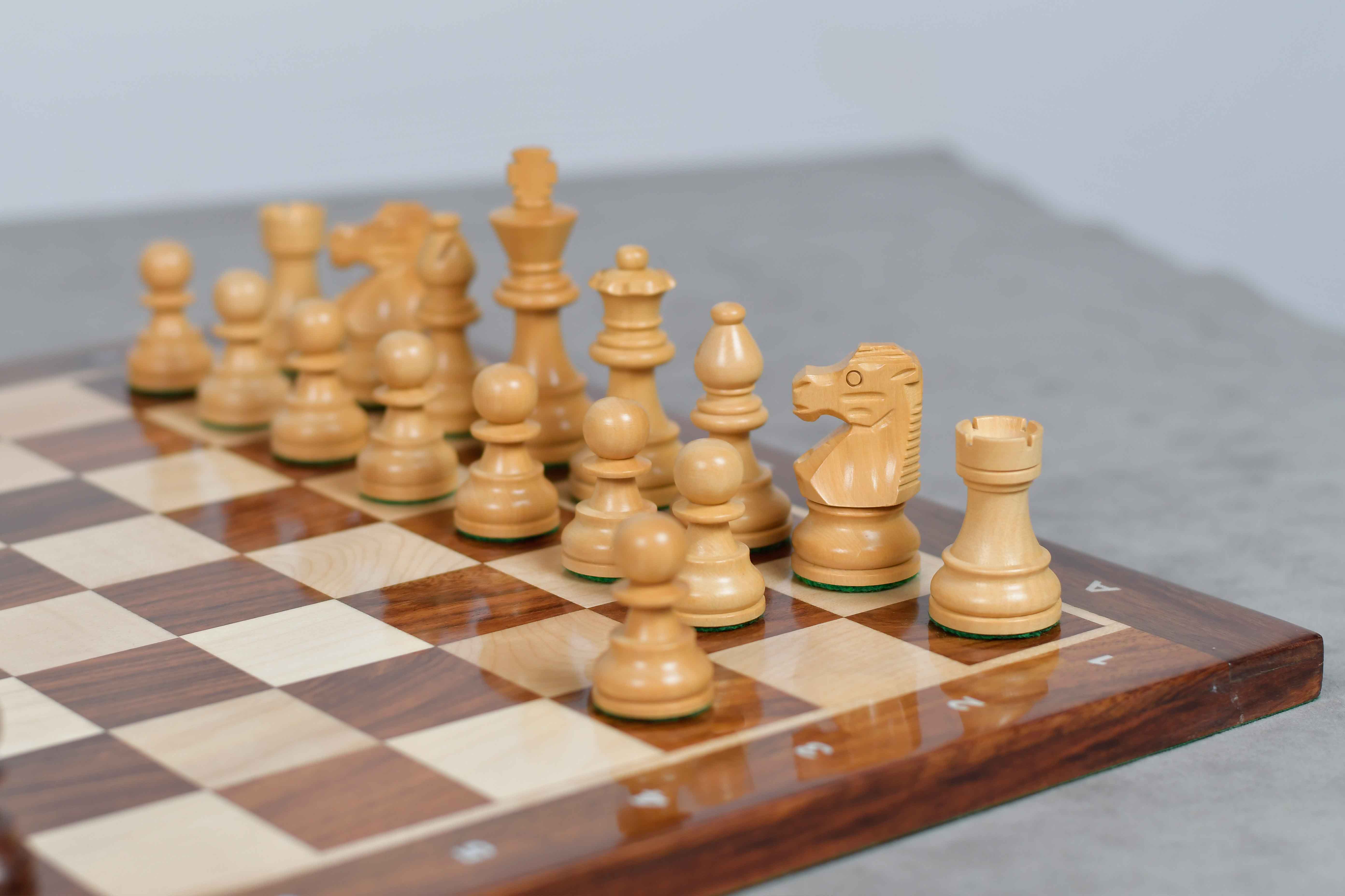 Sheesham chess pieces set up for play on the included 37cm sheesham and maple notation board