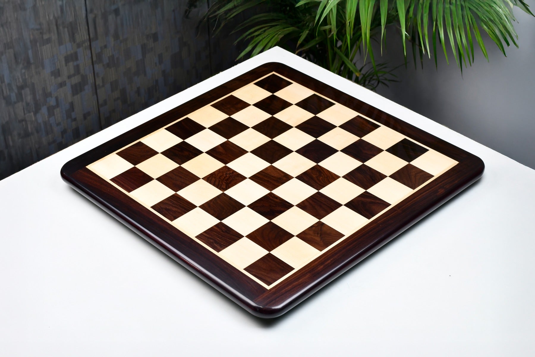Dark brown rosewood and maple 45mm square chess board at an angle