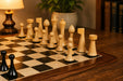 Ebonised chess pieces set up for play on the included 43cm hardwood board