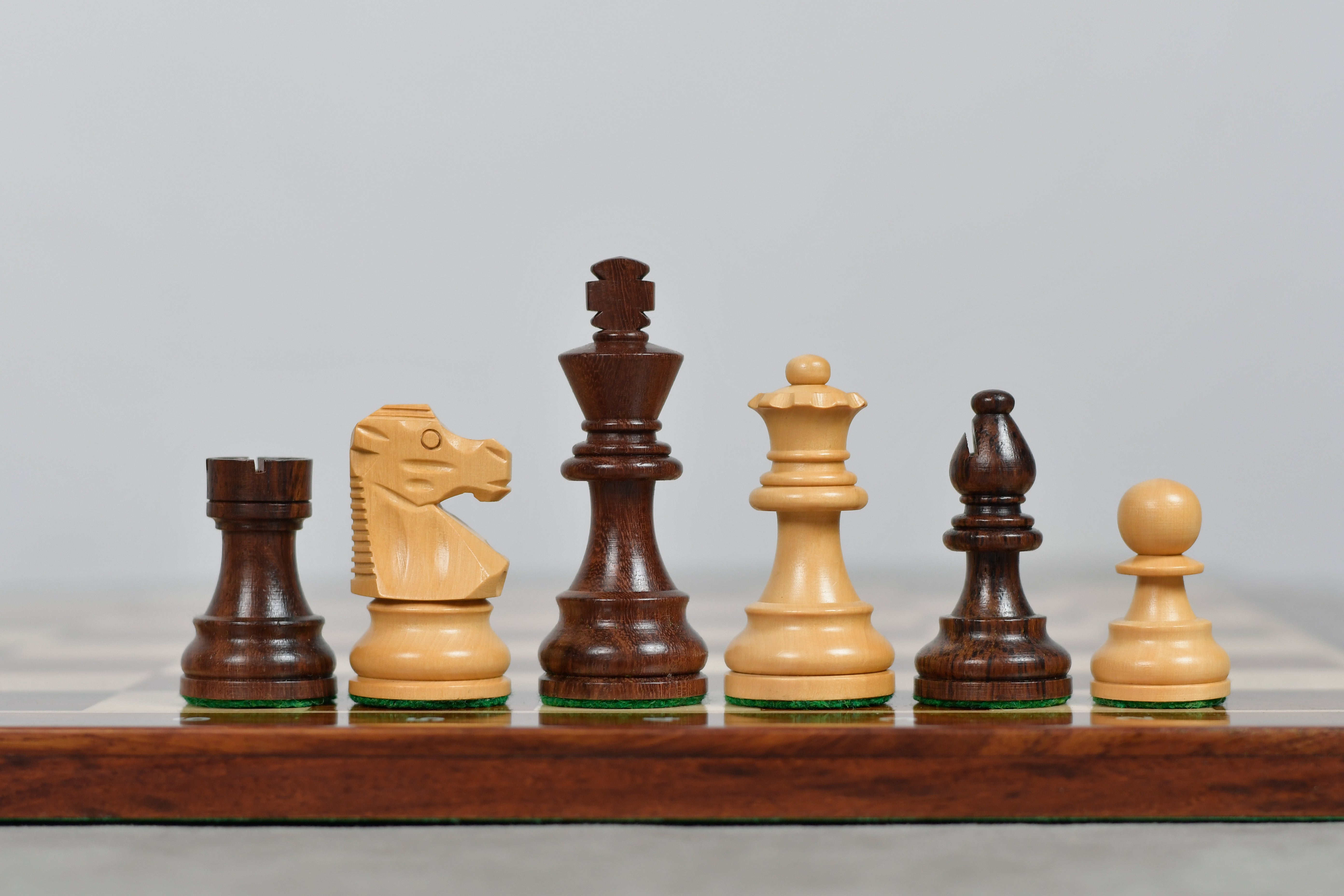 Knight carving detail on the French Lardy Compact chess set in sheesham and boxwood