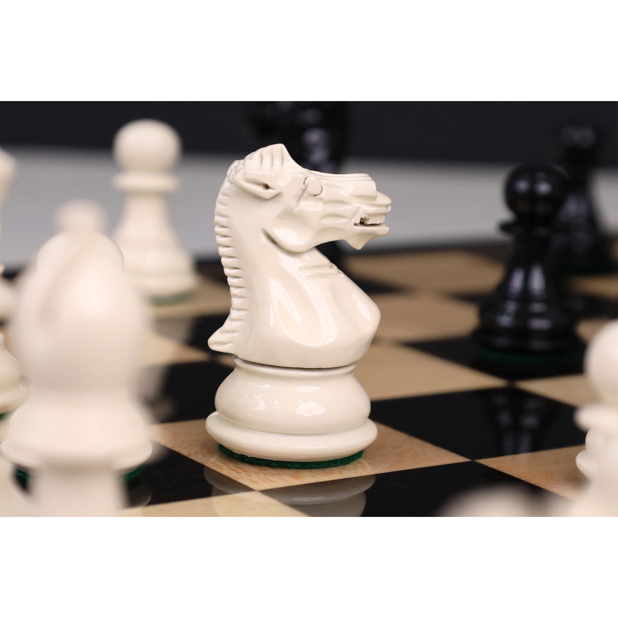 Black Painted Boxwood and Ivory Painted Boxwood chessmen with a 32mm king base