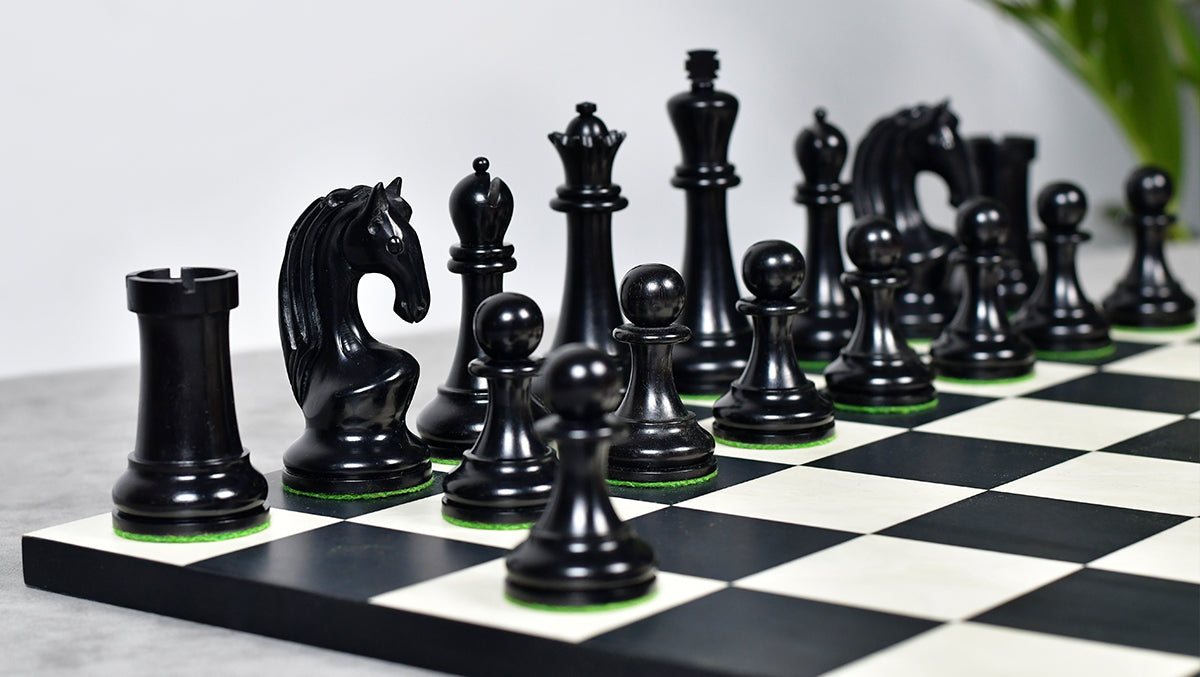 Genuine ebony and antiqued boxwood chess pieces with a 108mm king and weighted felted bases