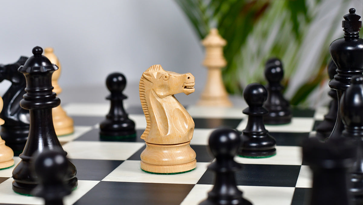 Double weighted ebonised boxwood chess pieces with 106mm king and spare queens
