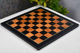 Golden brown wood grain tournament chess board photographed from above