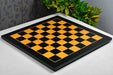 Midnight black and gold tournament chess board photographed from above