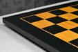 Midnight black and gold chess board showing its 19mm thickness