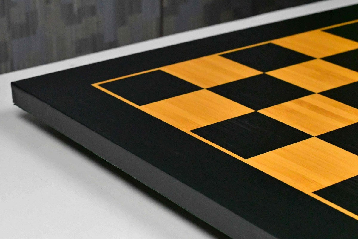 Midnight black and gold chess board showing its 19mm thickness