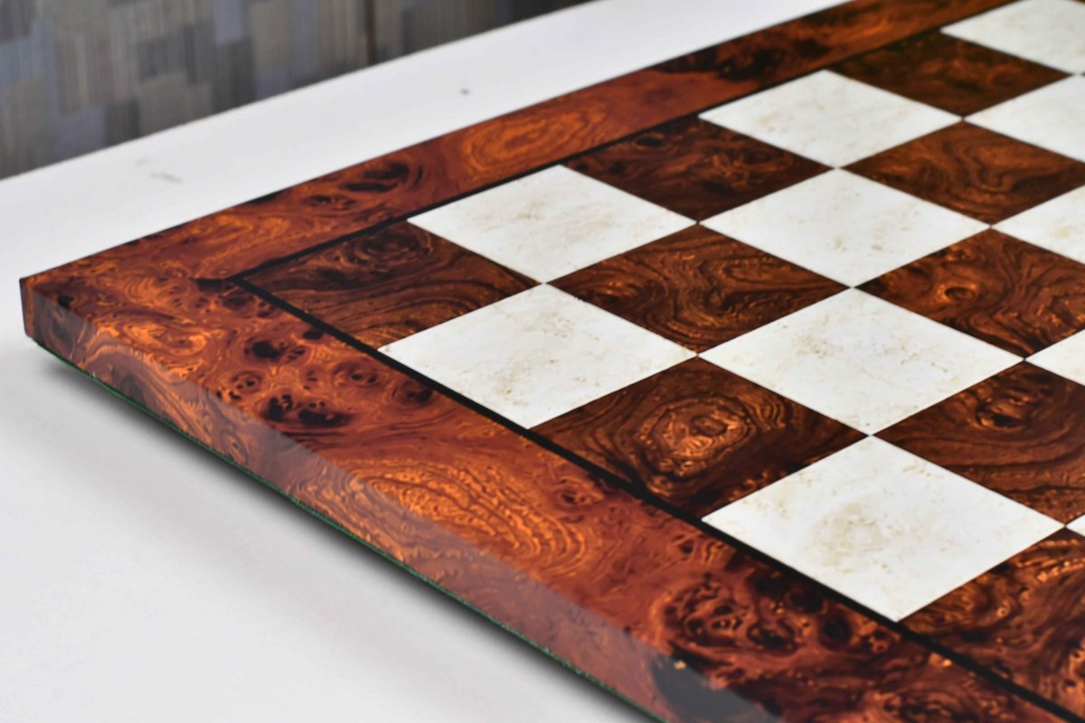 Reddish brown burl grain tournament chess board at an angle