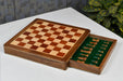 Padauk chess pieces set up for play on the included 30cm padauk and maple travel board