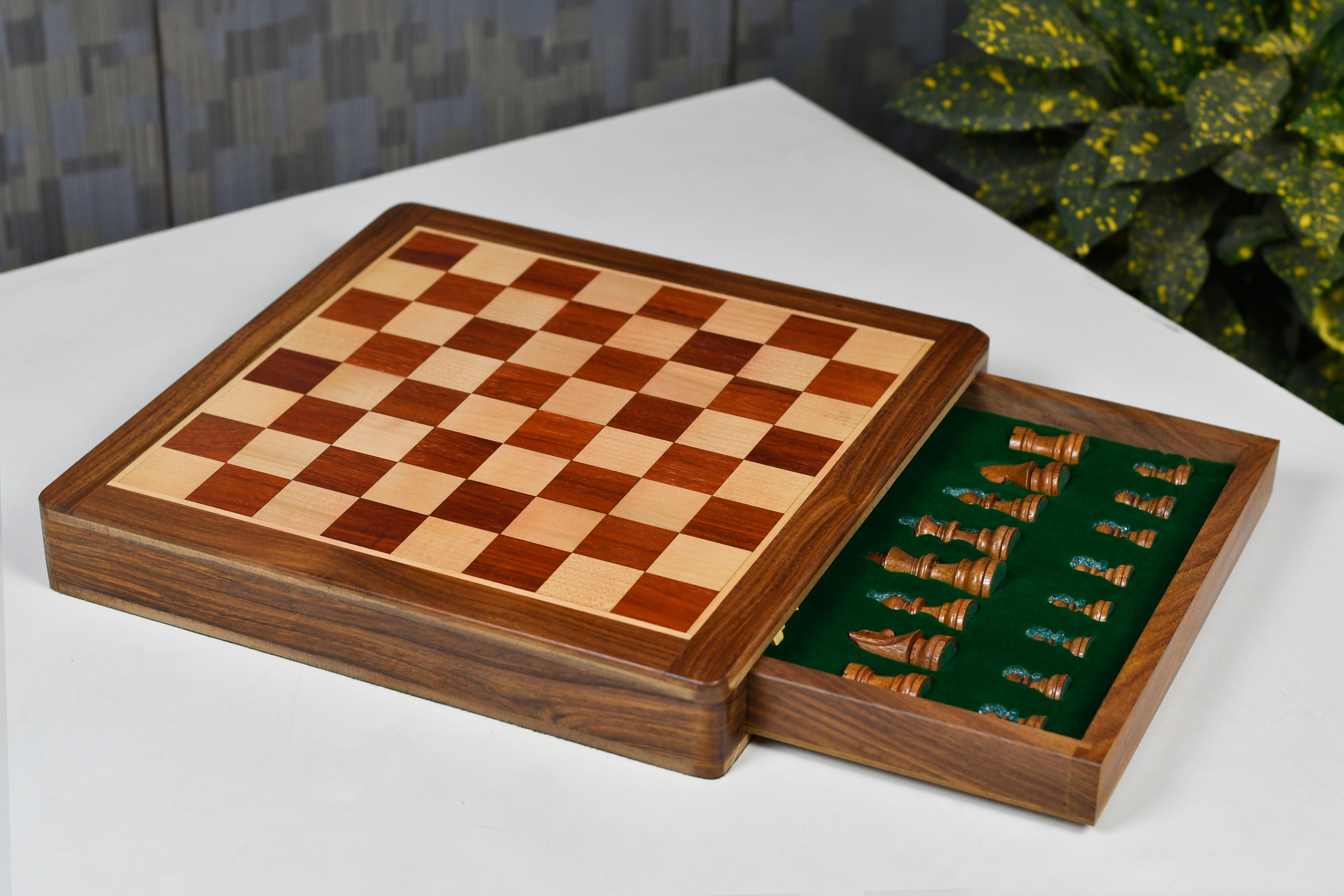Padauk chess pieces set up for play on the included 30cm padauk and maple travel board
