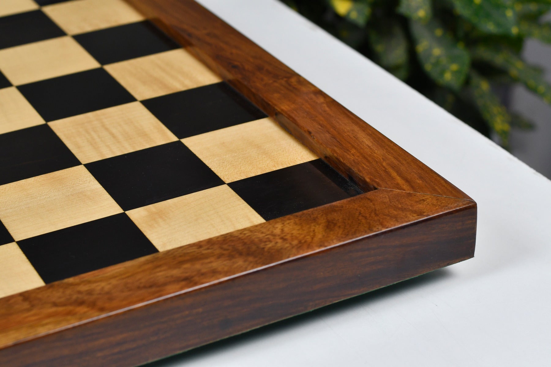 Ebony and maple chess board showing its 30mm thickness