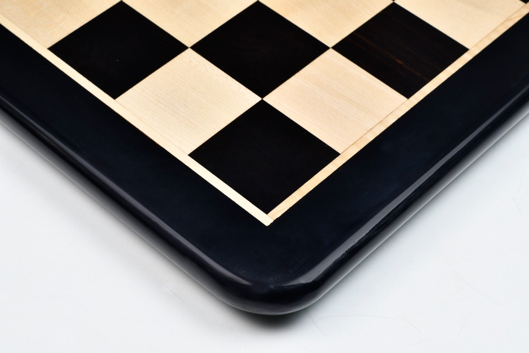 Ebony and maple 55mm square chess board at an angle