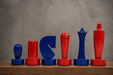 Sterling Chess Berliner Minimalist chess pieces in red and blue painted boxwood, 95mm king