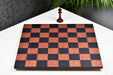 Minimalist black anigre and red ash burl chess board at an angle