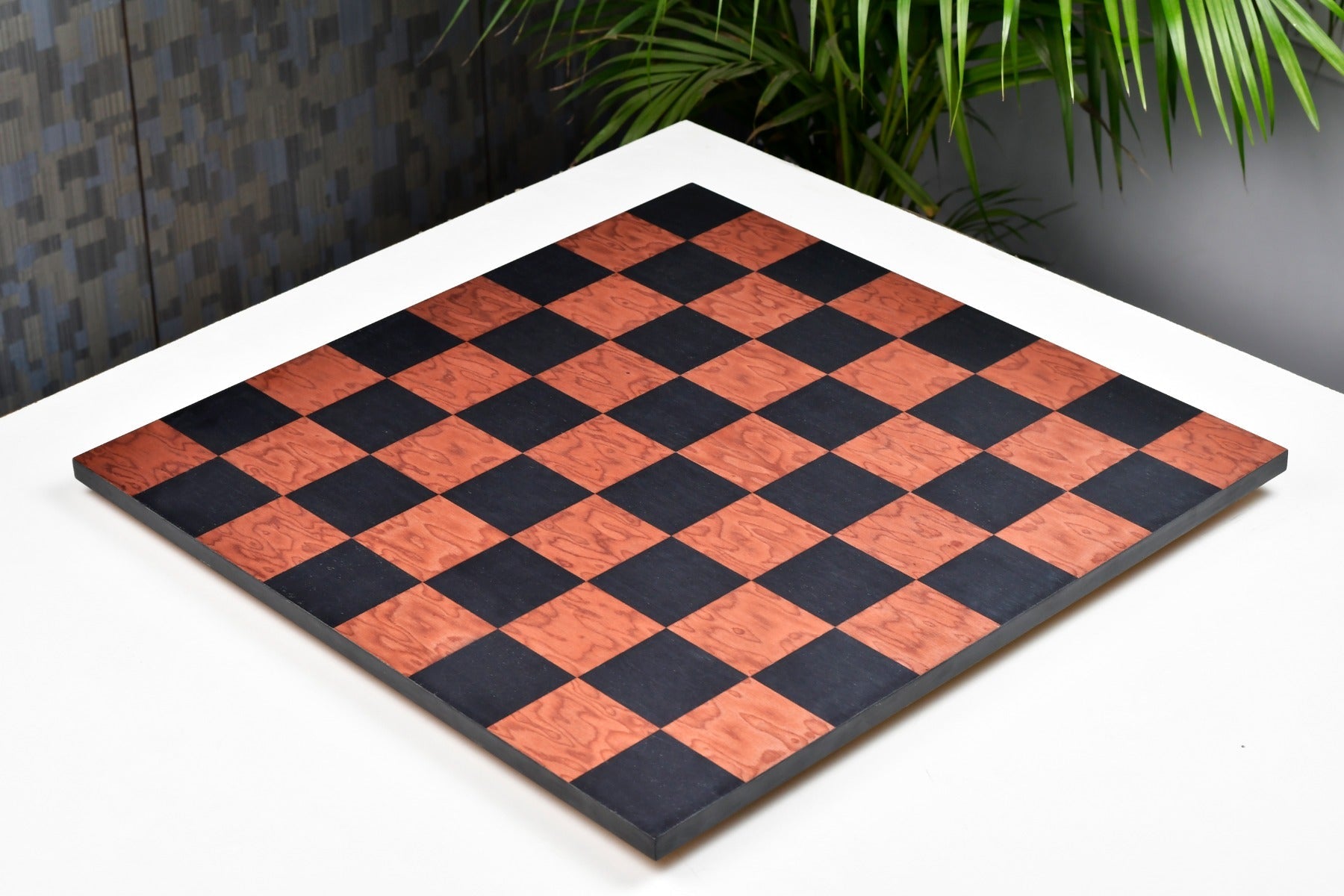 Black anigre borderless chess board, close detail of the grain