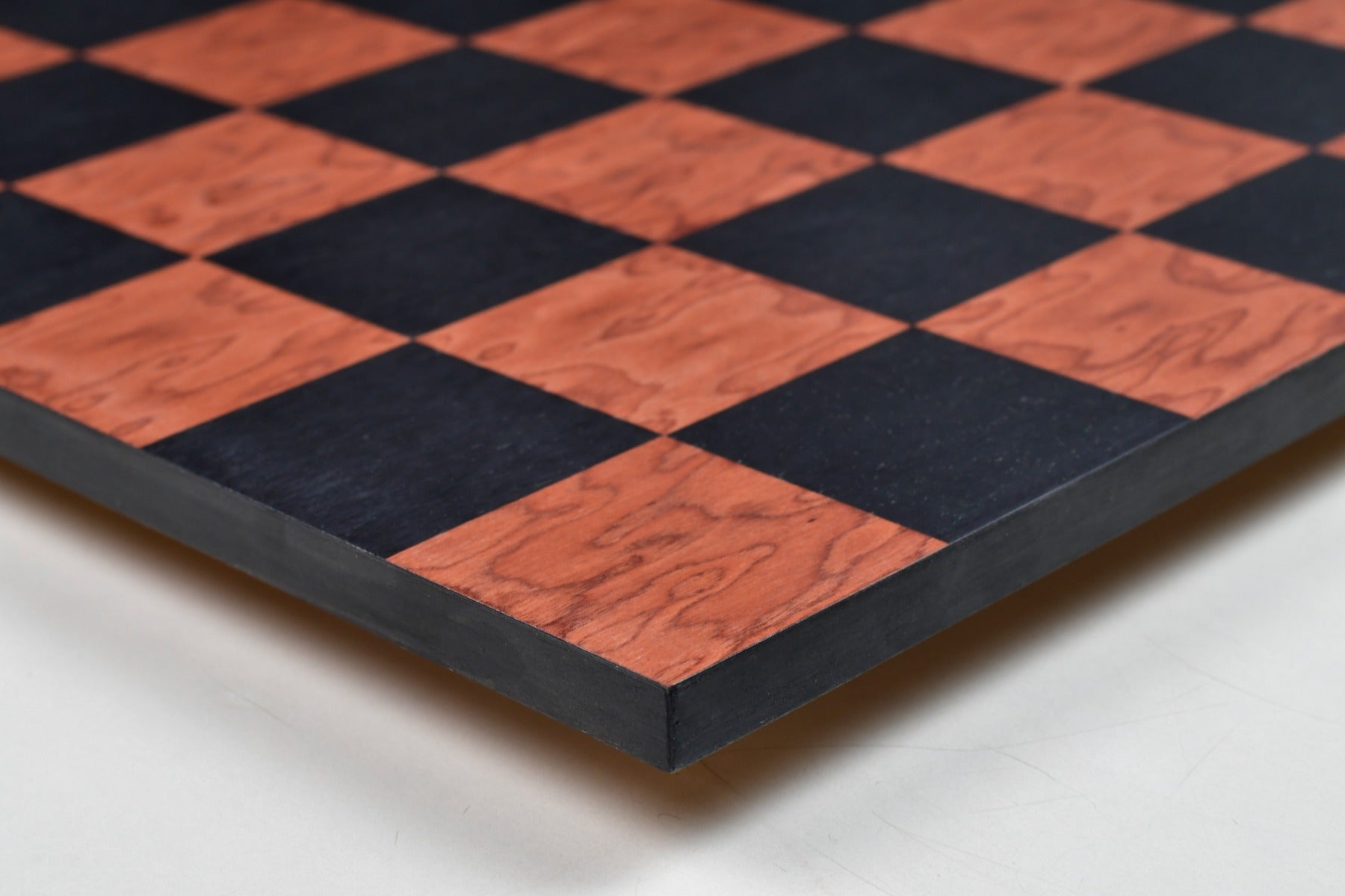 Matte borderless black anigre chess board, edge view