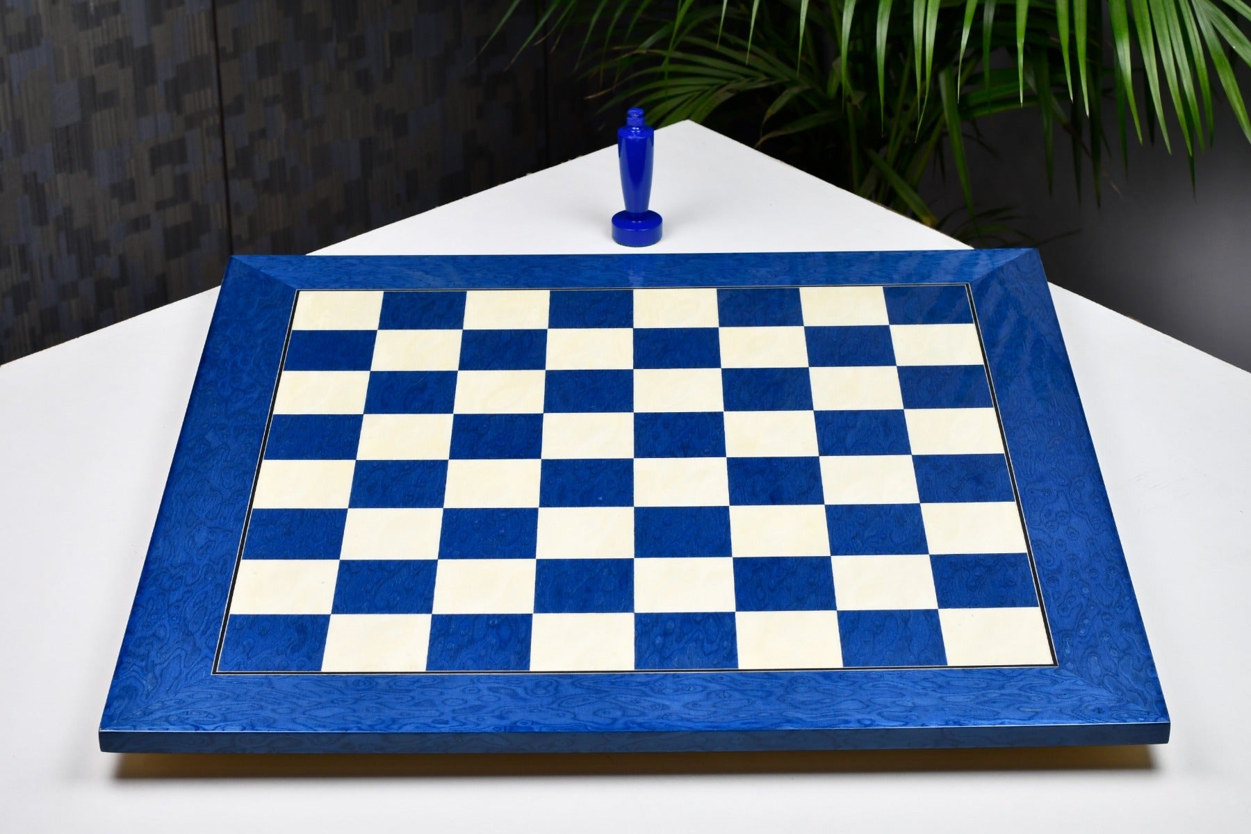 Blue ash burl and white erable chess board at an angle