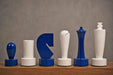 Sterling Chess Berliner Minimalist chess pieces in blue and white painted boxwood, 95mm king