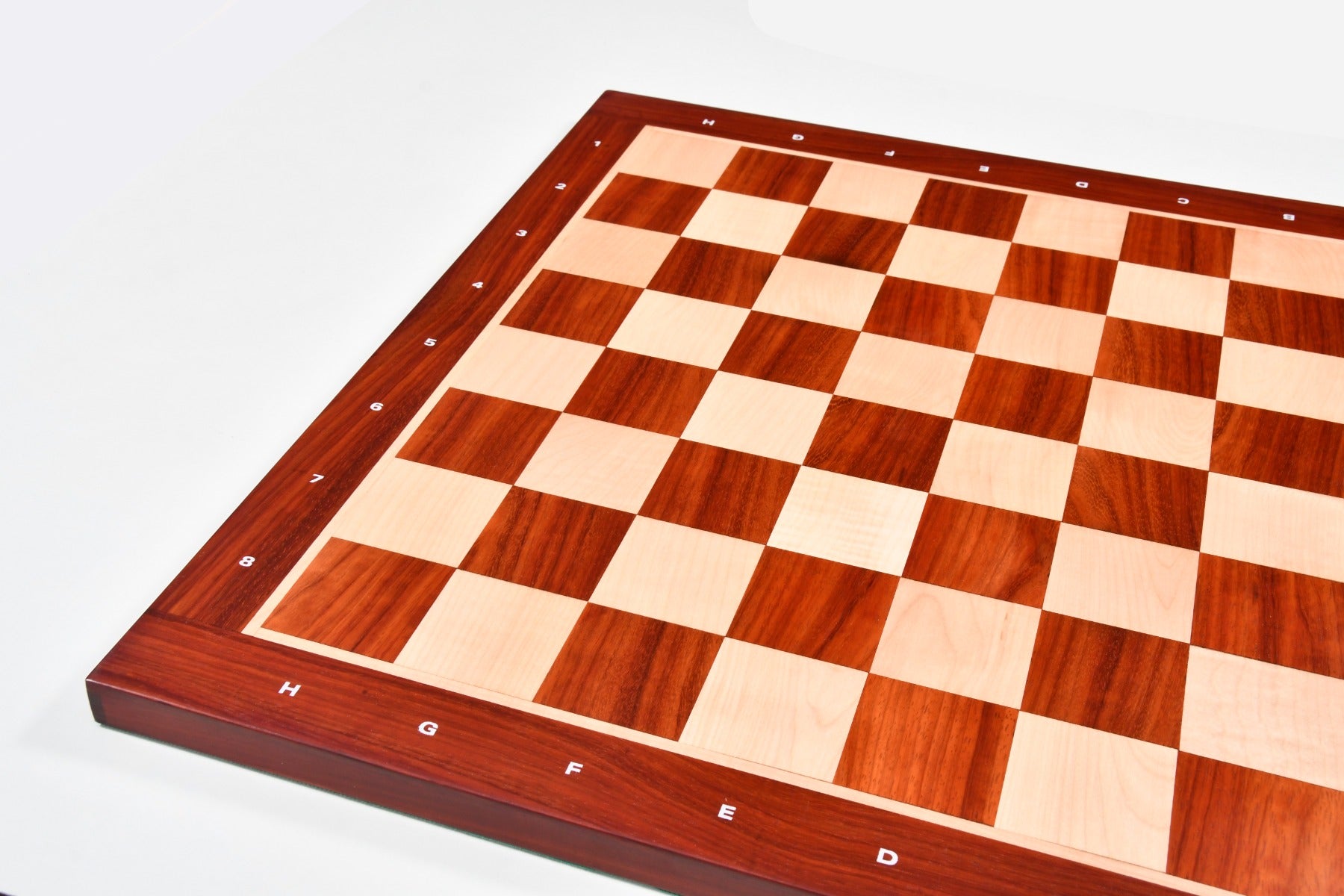 Bud rosewood and maple notation chess board showing its 22mm thickness