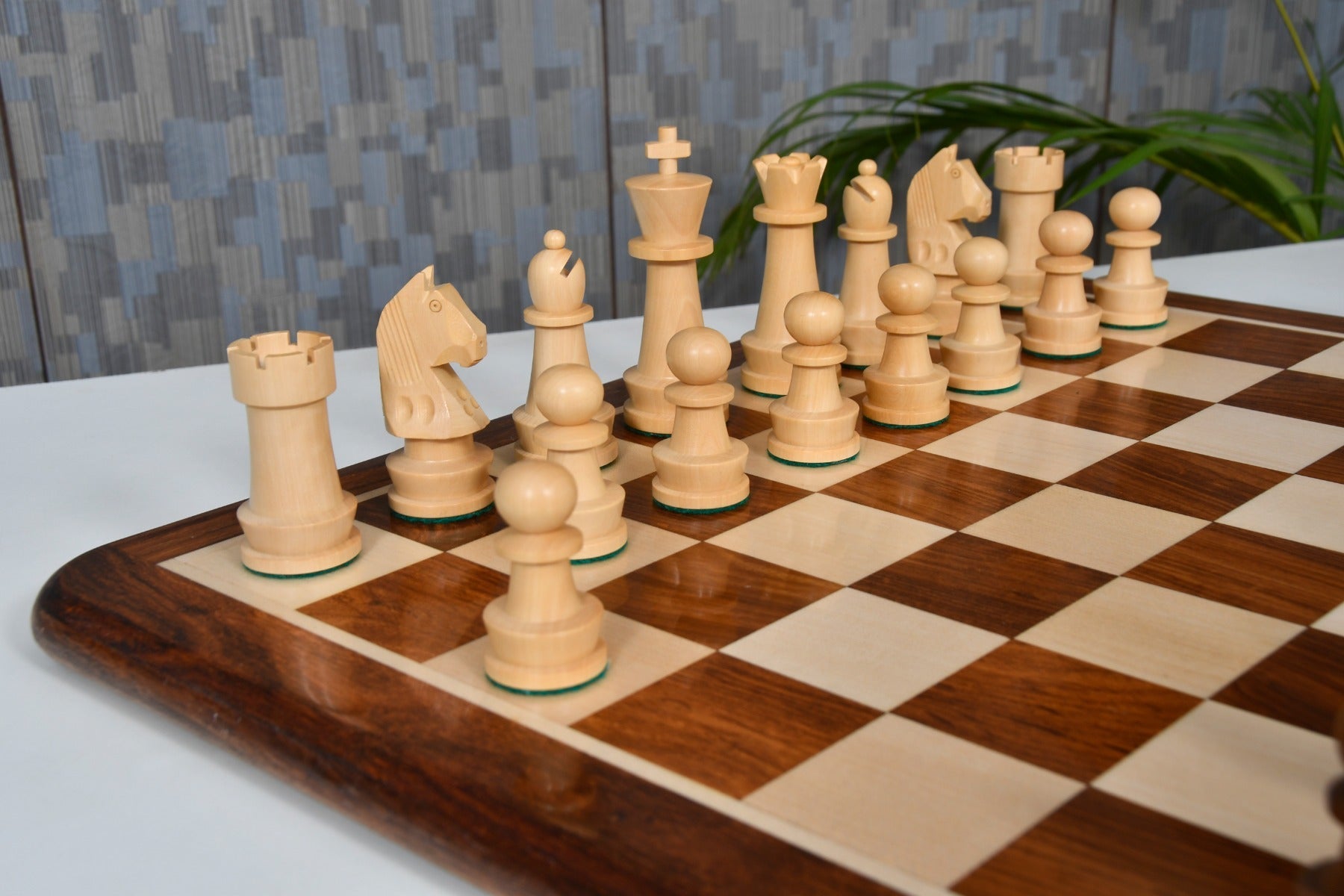 Sheesham chess pieces set up for play on the included 48cm solid sheesham and maple board