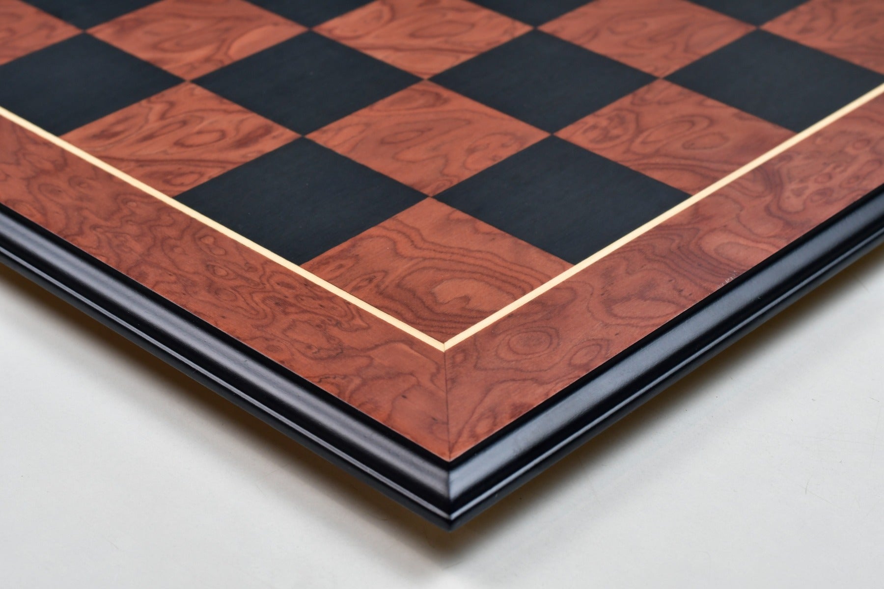 Red ash burl veneer chess board, close detail of the moulded edge