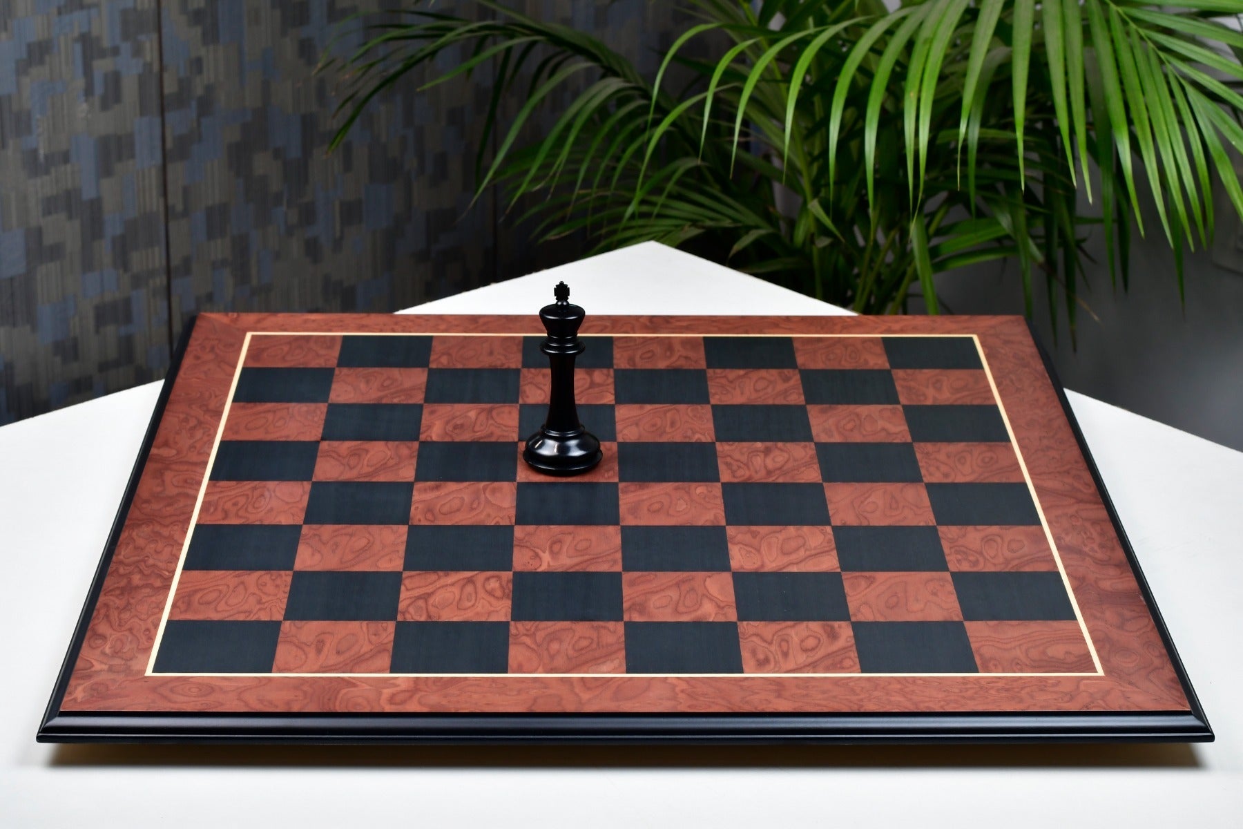 Black anigre and red ash burl chess board at an angle