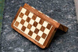 Travel chess set folded closed with the chessmen in their fitted slots