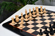 Genuine ebony chess pieces set up for play on the included 46cm ebony and boxwood board