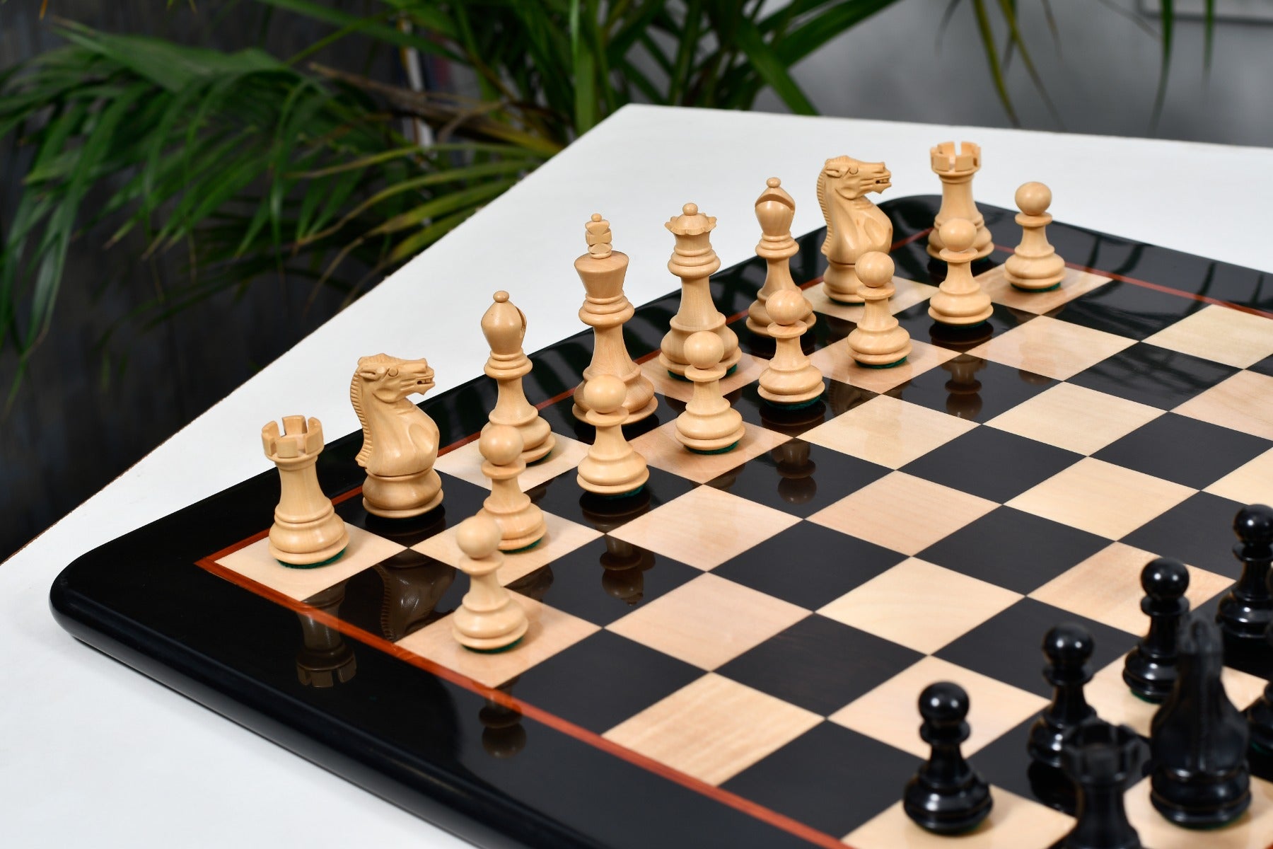 Genuine ebony chess pieces set up for play on the included 46cm ebony and boxwood board