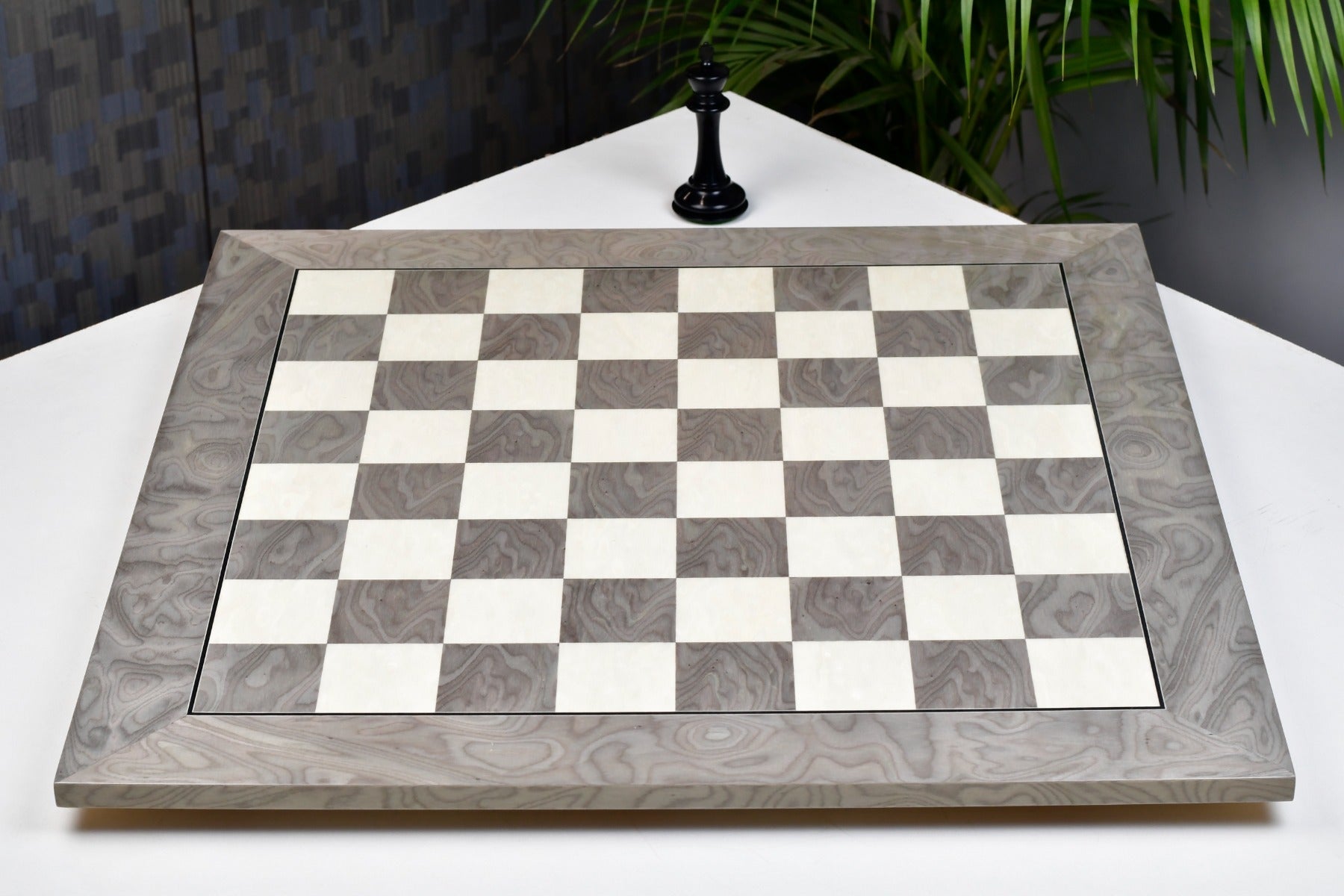 Grey ash burl and white erable chess board at an angle