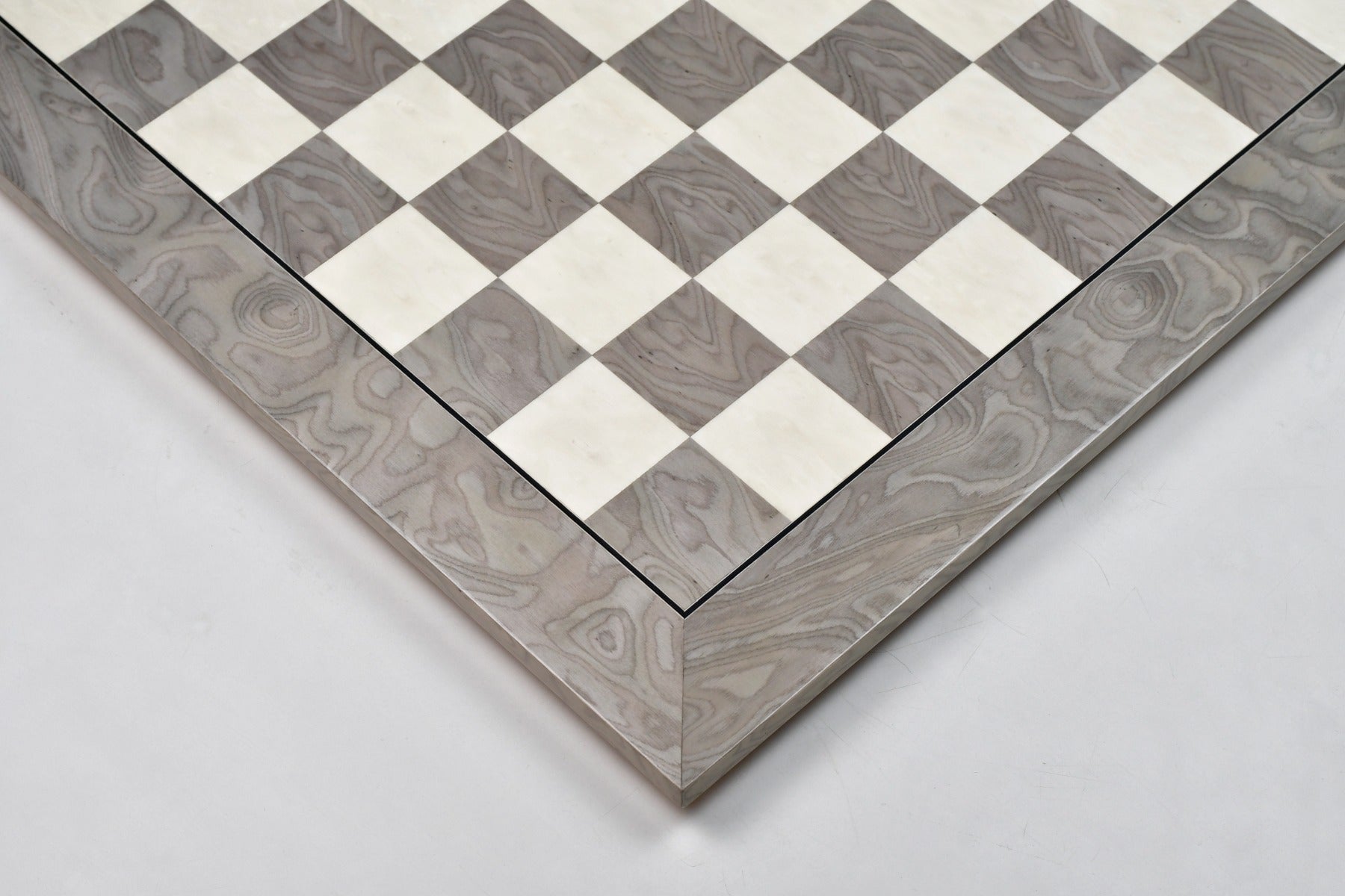 Grey ash burl hi-gloss chess board photographed from above