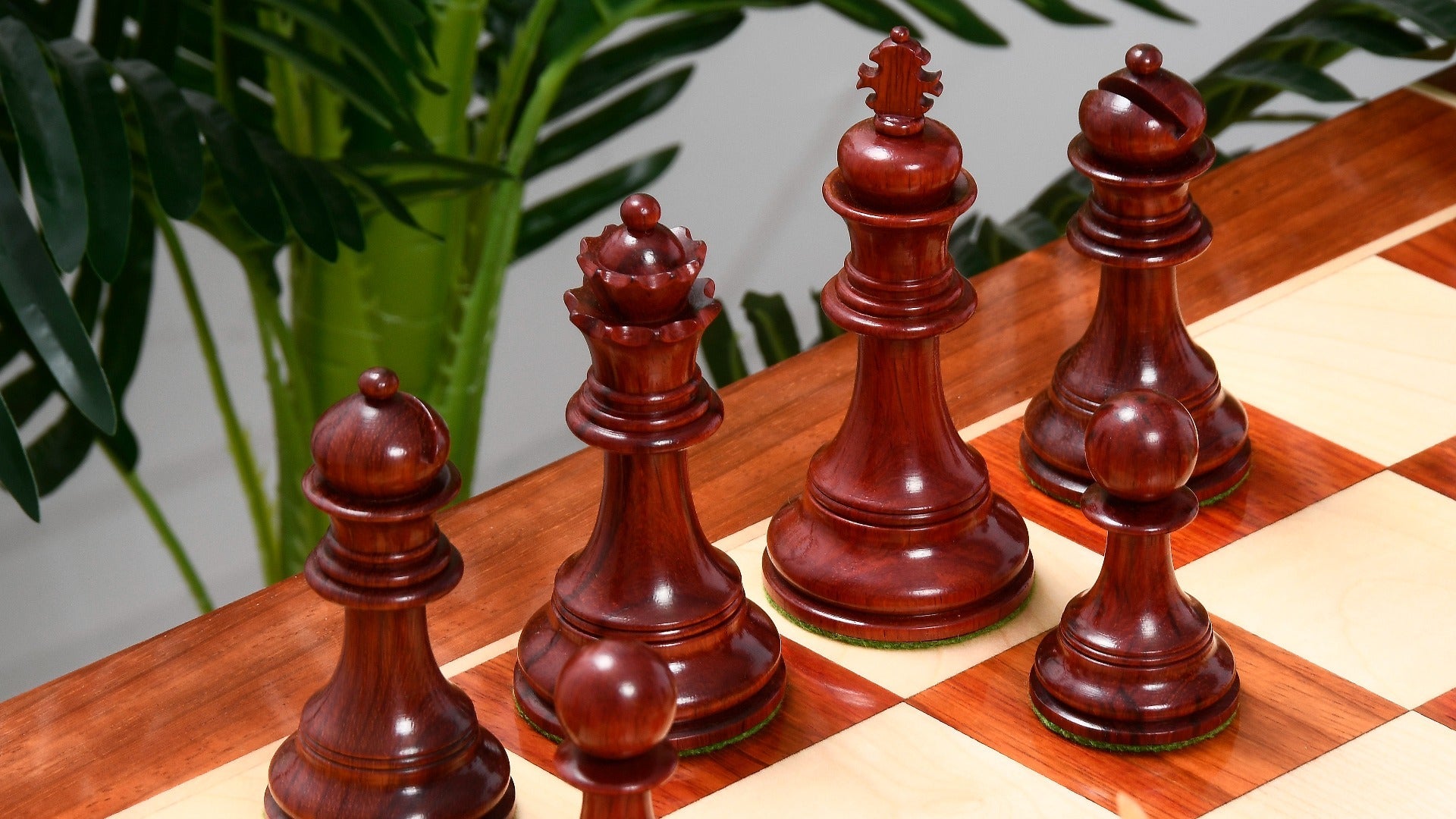 Bud rosewood chess pieces set up for play on the included 58cm bud rosewood and maple board