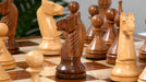 Sheesham chess pieces set up for play on the included 53cm sheesham and boxwood board
