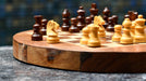 Sheesham and maple folding round travel chess set viewed from above