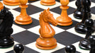 Genuine ebony chess pieces set up for play on the included 60cm black anigre and maple board