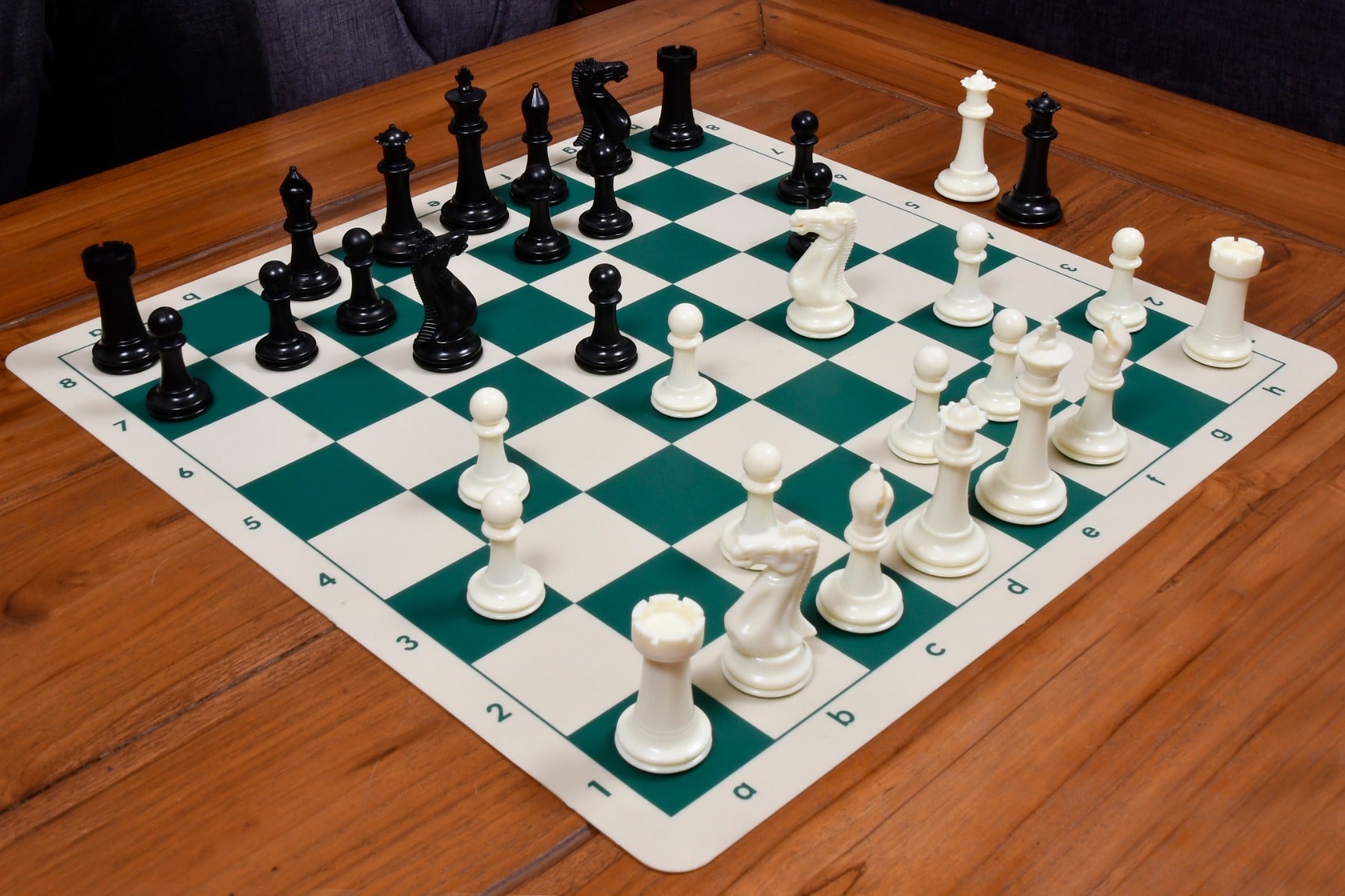 Ivory white and black plastic chess pieces with a 98mm king