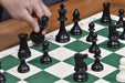 Ivory white and black plastic chess pieces with a 97mm king