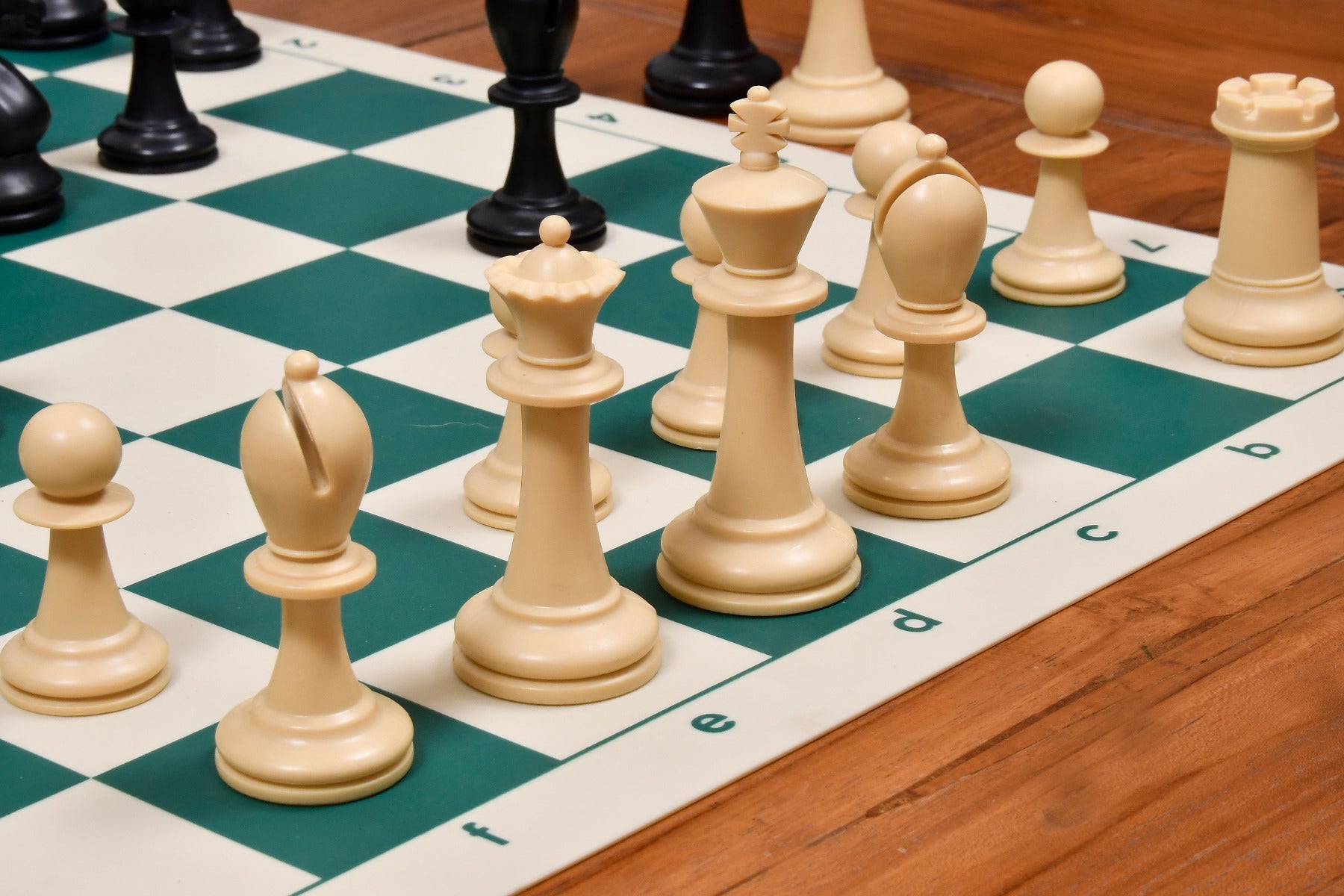 Natural white and black plastic chess pieces with a 97mm king