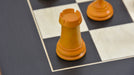 Genuine ebony chess pieces set up for play on the included 60cm black anigre and maple board