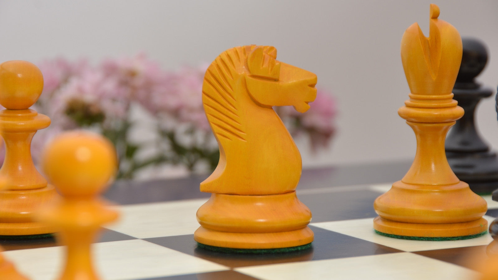 Knight carving detail on the B and Co 1860s Antique chess set in genuine ebony and antiqued boxwood, 60cm Anigre & Maple