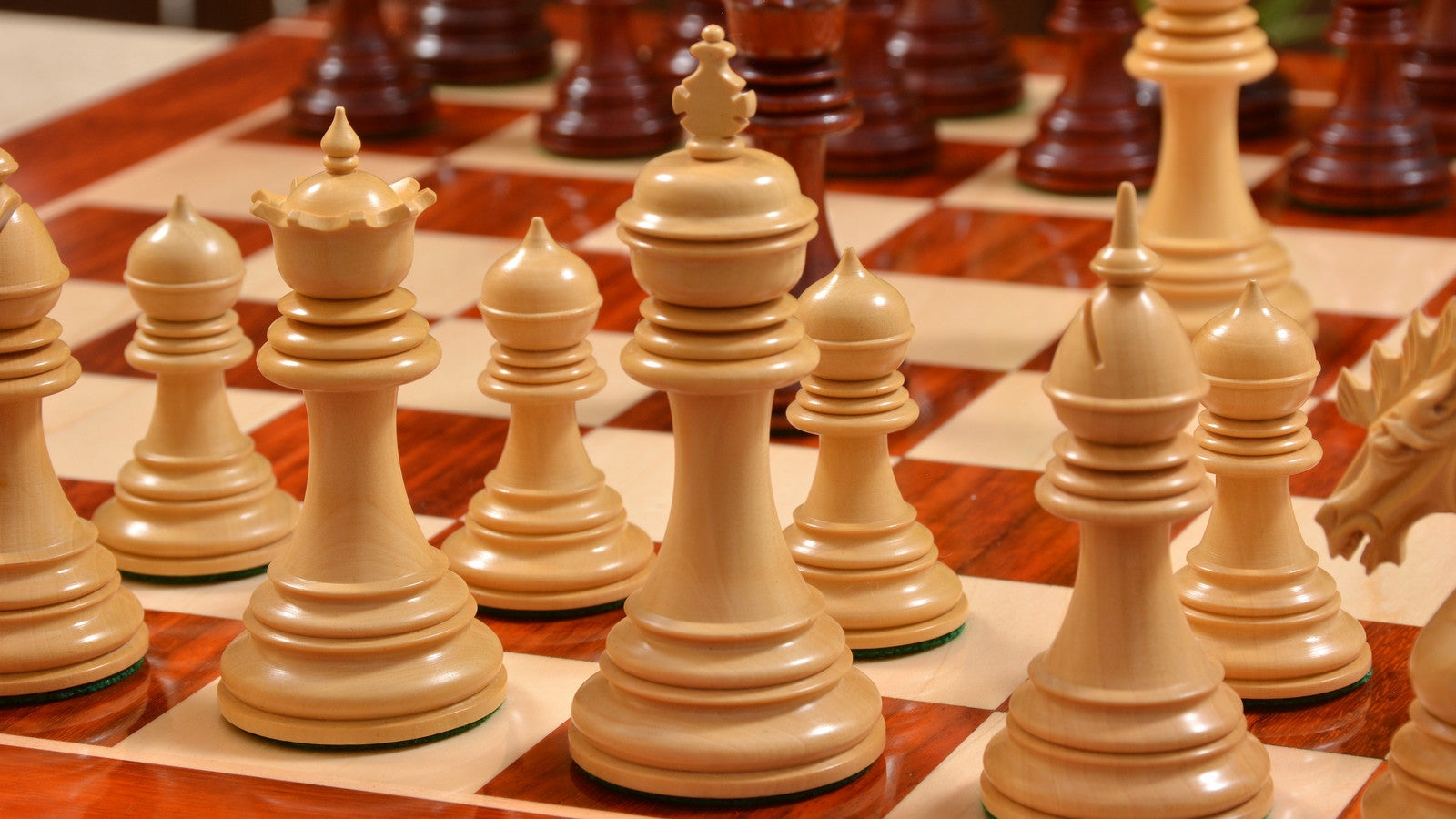 Bud rosewood chess pieces set up for play on the included 58cm solid bud rosewood and maple board