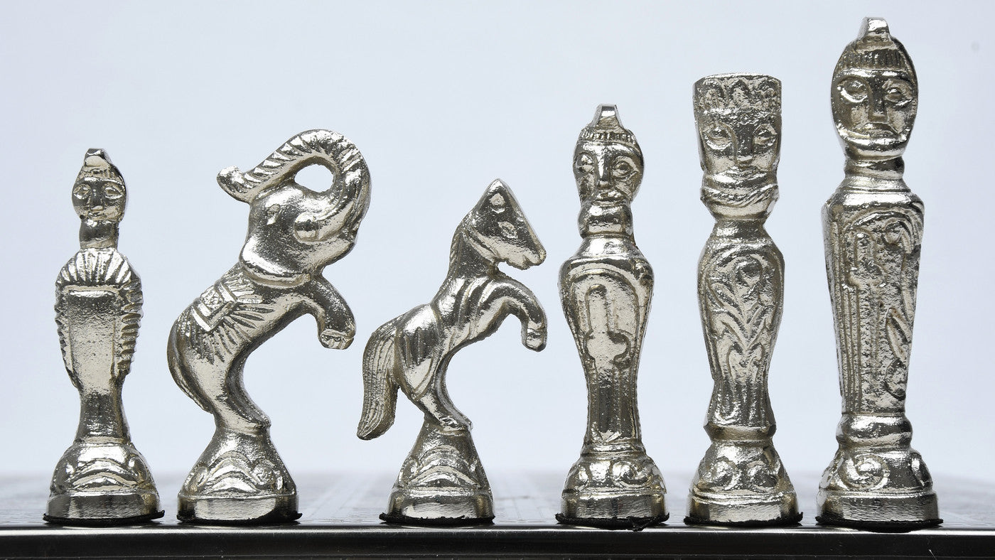 Shiny black brass vintage chess pieces, detail of the crowned king