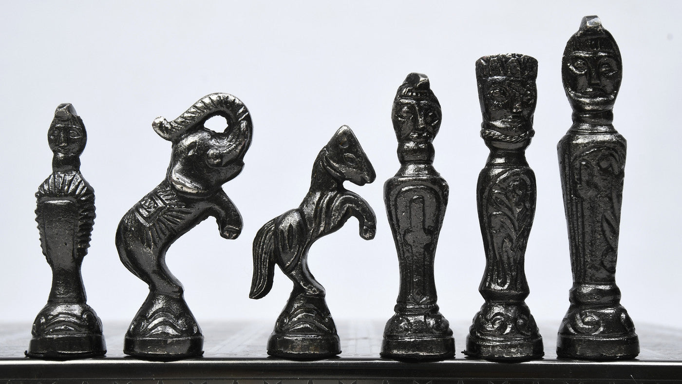 Black and silver brass chess set arranged on 40mm squares
