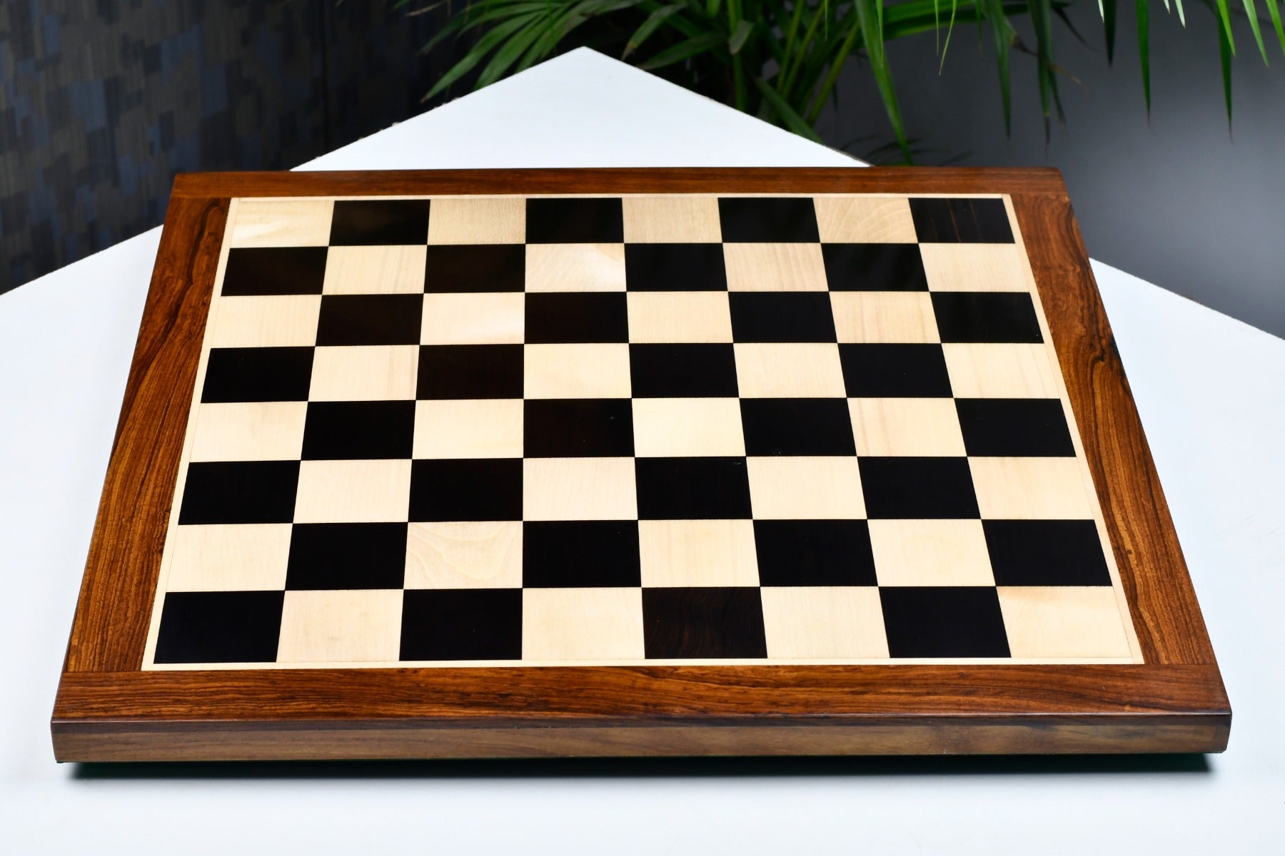 Ebony and maple sheesham border 50mm square chess board at an angle