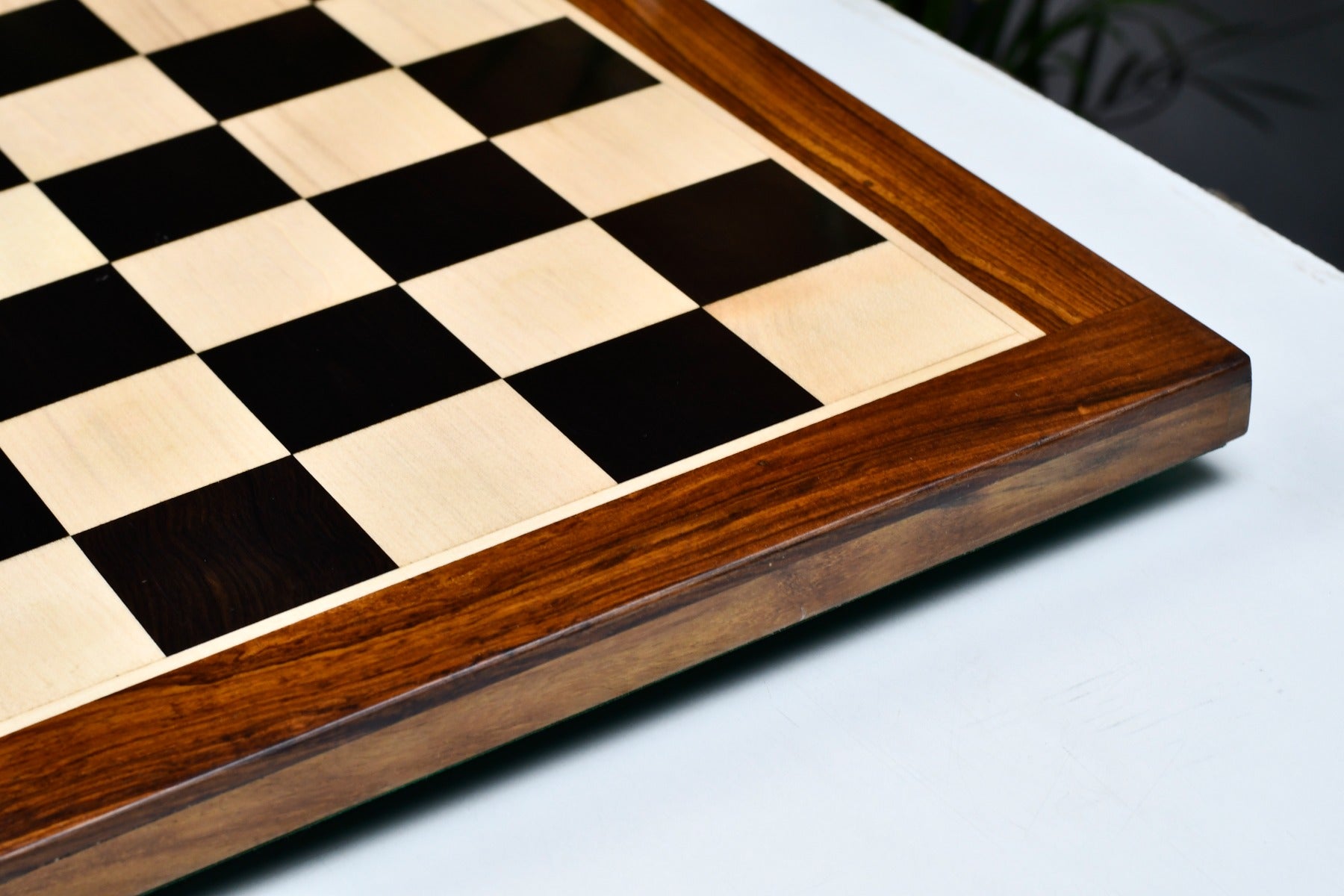 Ebony and maple 19 inch chess board showing its 25mm thickness